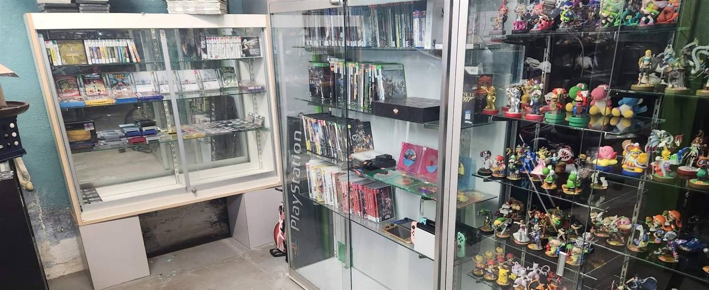 Display cases of handheld games, Xbox and PlayStation titles, and amiibo