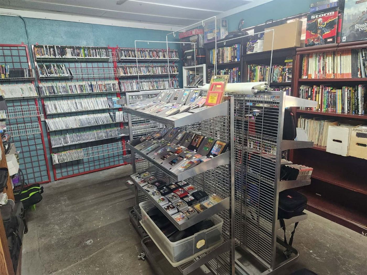 NES and N64 cartridge racks with the disc wall behind