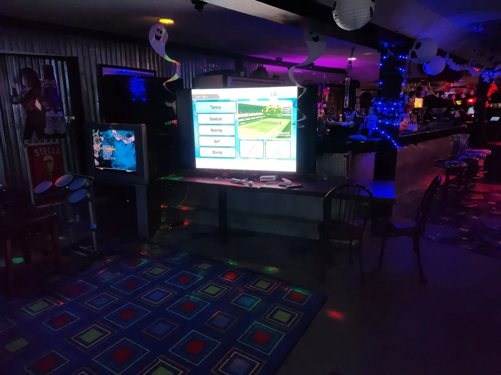 Big-screen Wii Sports next to the drum kit for the music games
